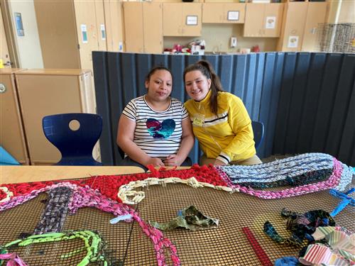 Student and Mentor work on weaving project
